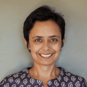 Headshot of Purnima Chawla in front of a blank gray background