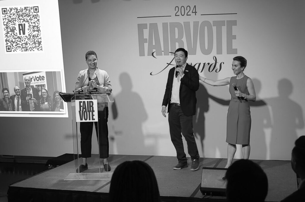 Photo of Danielle Allen, Andrew Yang, and Meredith Sumpter on stage at the FairVote Awards