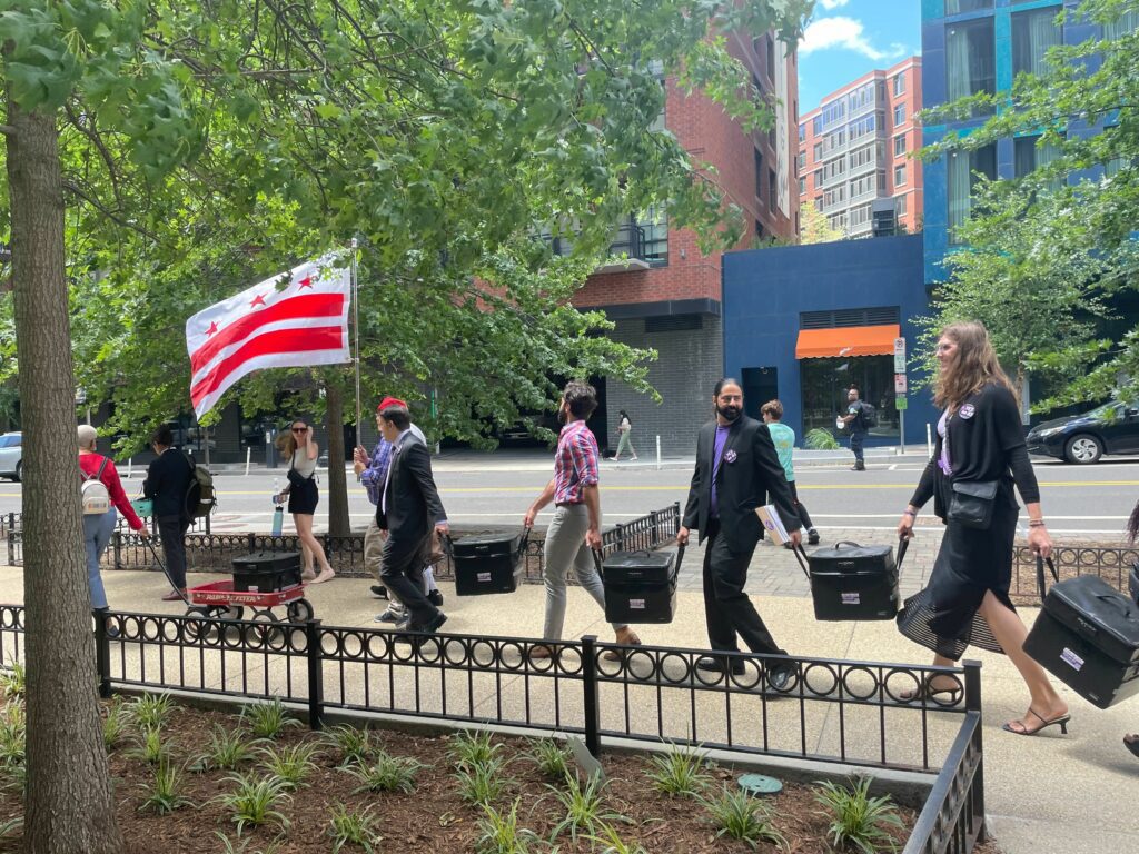 Supporters of Initiative 83 walking signatures to the DC Board of Elections