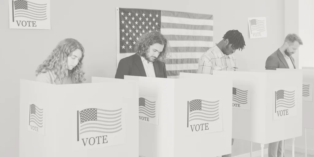 Photo of four voters casting their ballots in voting booths